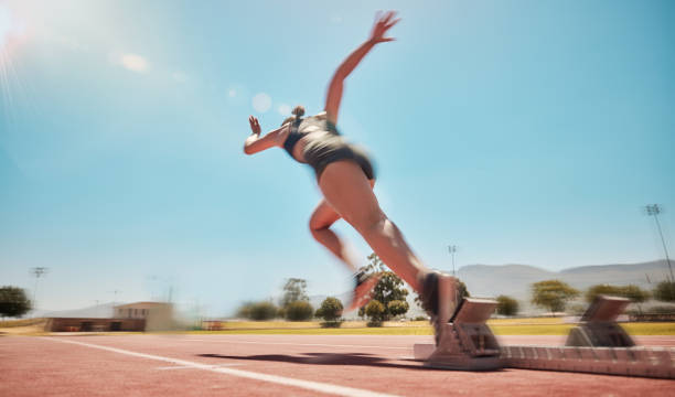 Speed, track start and woman running for marathon race workout, fitness or exercise for leg power action. Health commitment, blue sky flare and fast sports girl, athlete or cardio runner training